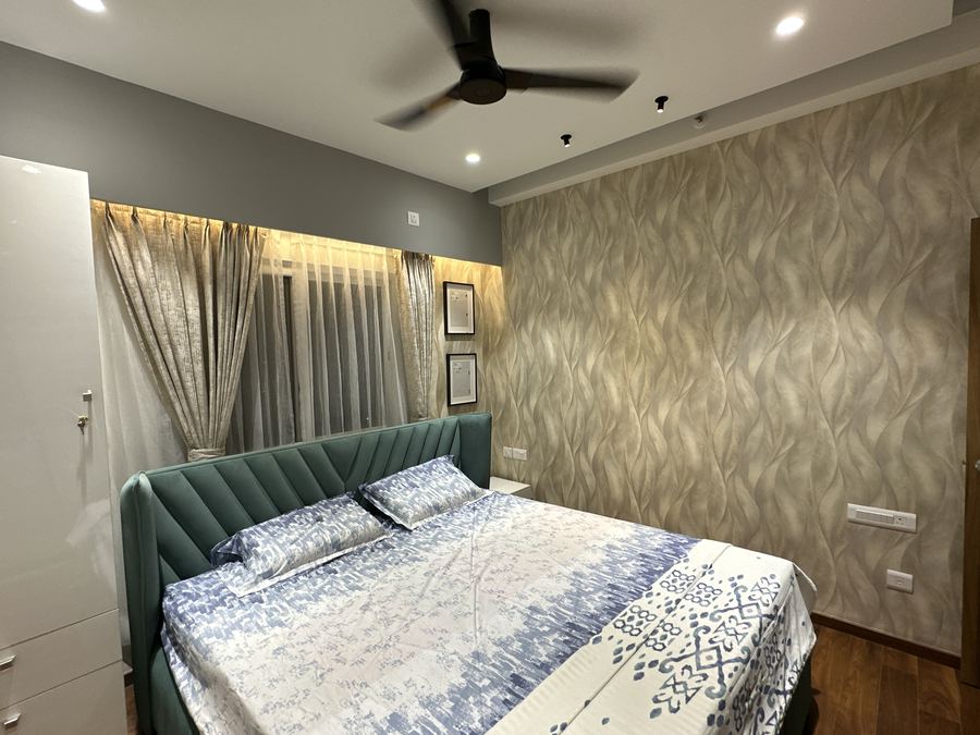 Bedroom with textured wave-pattern wallpaper accent wall